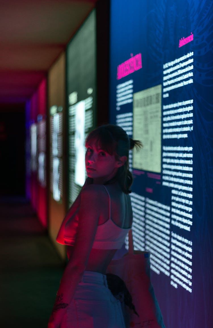 Woman In Dark Room With Digital Exhibition