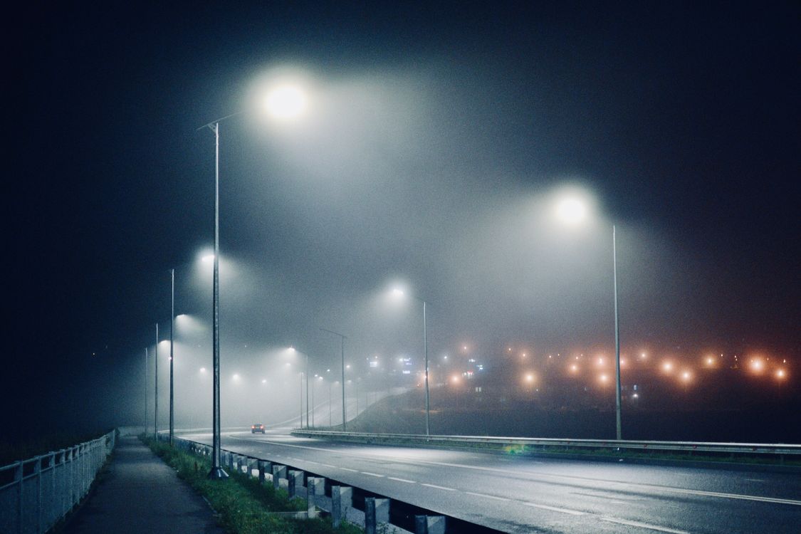 Lighted Street Lights Between A Highway Free Stock Photo lighted-street-lights-between-a-highway-free-stock-photo