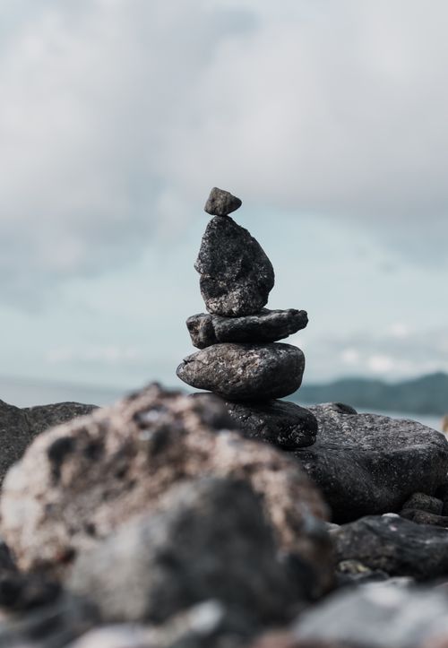 Free A calm scene of stacked rocks with a cloudy sky backdrop, showcasing balance and tranquility. Stock Photo