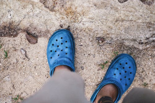 Free Person Wearing Blue Rubber Clogs Stock Photo