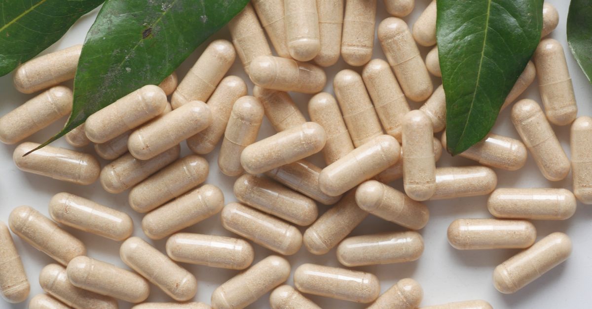 Organic medicine capsules with fresh green leaves on a white background. - Evidence evidence guide for beta glucan immune support randomized trial