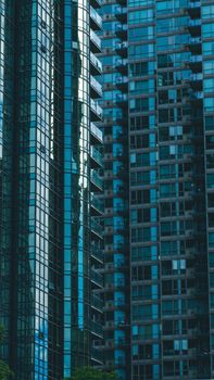 Striking vertical view of modern glass skyscrapers in Vancouver, showcasing urban design and architecture.