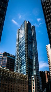 View of contemporary skyscrapers in downtown Vancouver against a clear blue sky.