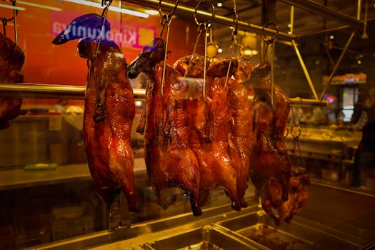 Succulent roasted ducks hanging on display in a Seattle butcher shop window, showcasing culinary craftsmanship.