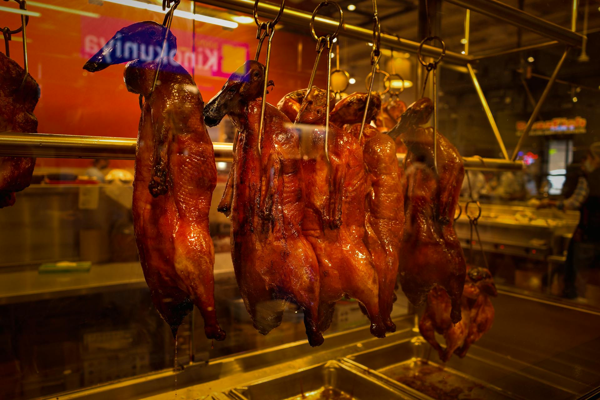 Roasted Ducks Hanging on Display in the Window of a Butchers