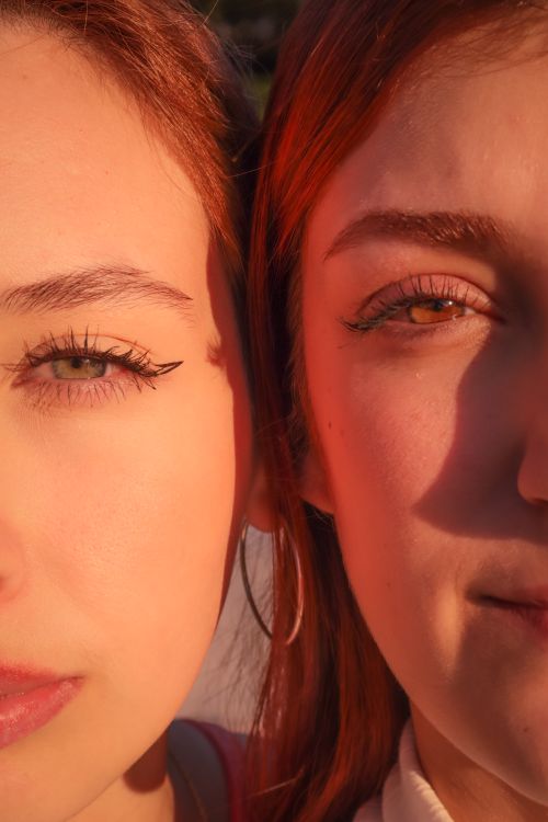 Free Intimate close-up of two young women enjoying the golden hour sunlight in Brazil. Stock Photo