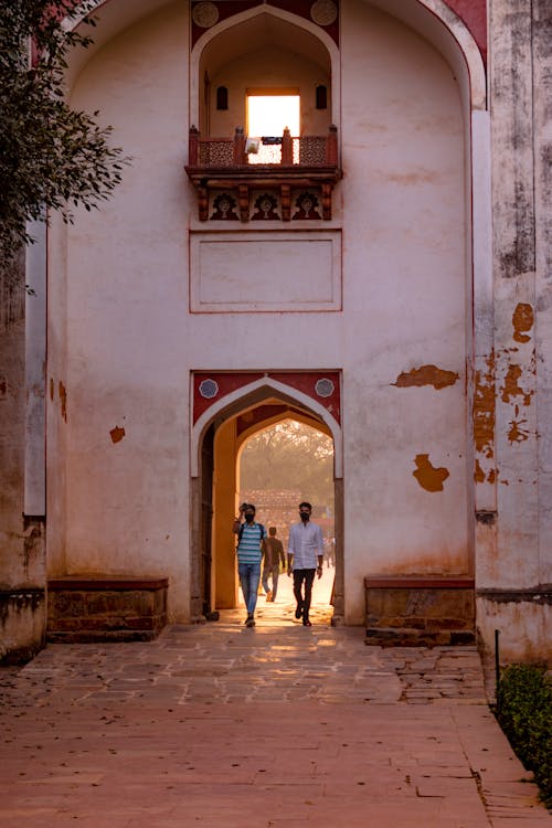 Men Walking through the Archway 