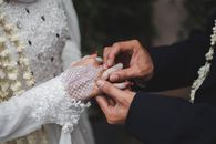 Man Putting a Wedding Ring on his Bride