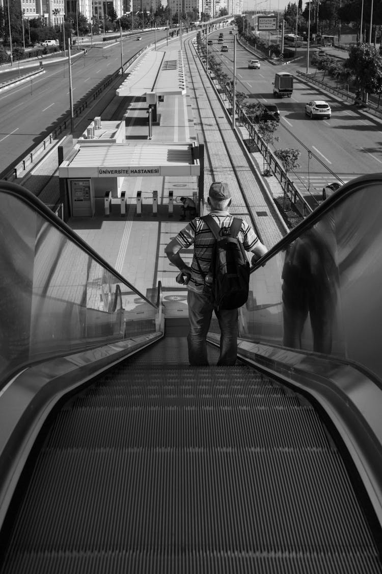 A Man Going Down Riding An Escalator