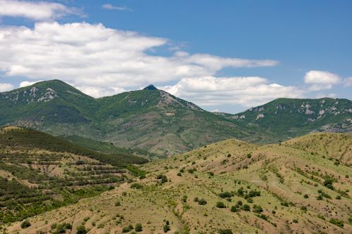 Free A breathtaking view of green mountains and a clear blue sky, perfect for nature lovers. Stock Photo