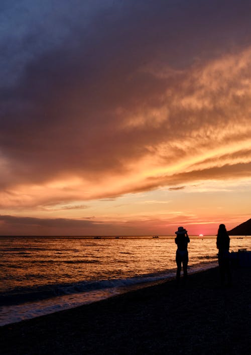 Silhouette of Women on the Beach at Sunset