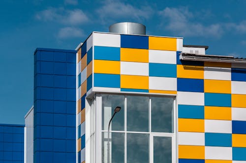 Facade of a Modern Building with Blue, Yellow and White Tiles on the Exterior 