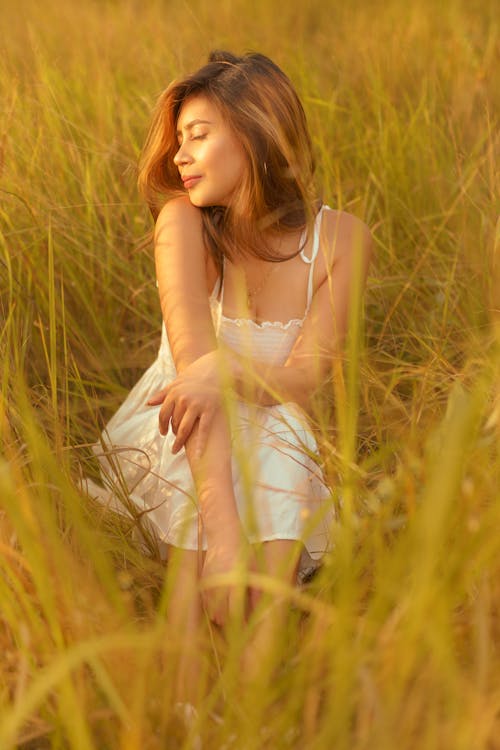 Beautiful Woman Sitting in the Meadow 