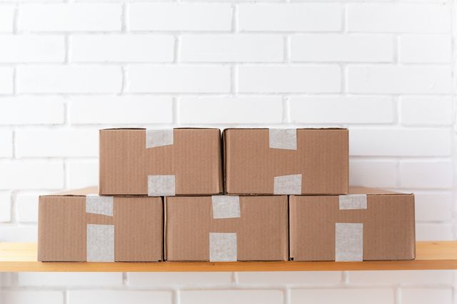 Stack of taped cardboard boxes ready to ship — photo by Ayrat on Pexels