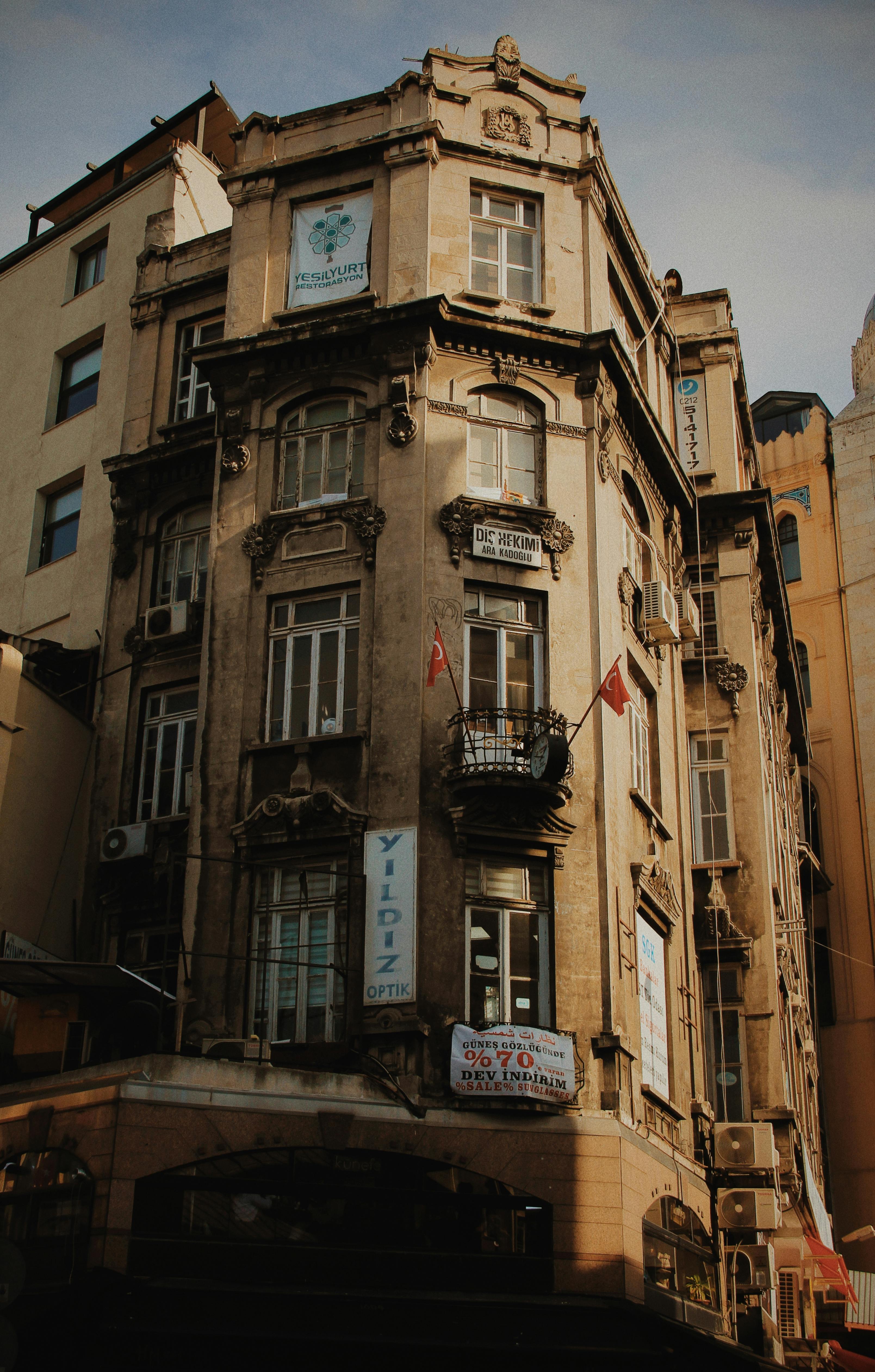 Low angle view of an ornate historic building facade in an urban city setting.