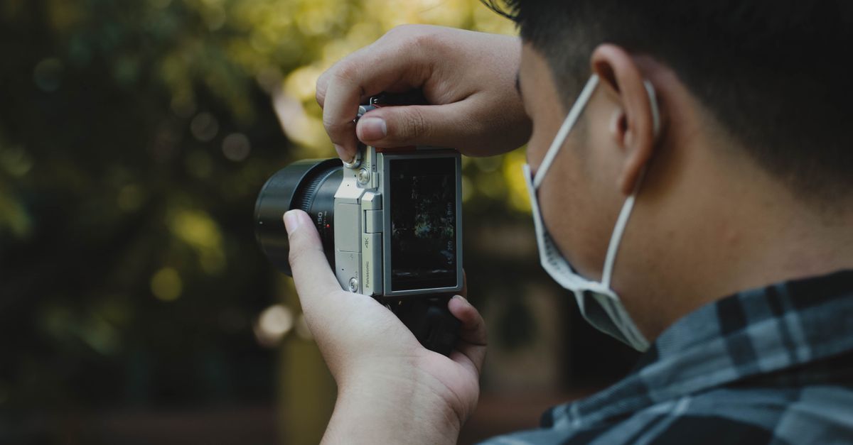 Camera In Use A Person Using Camera · Free Stock Photo