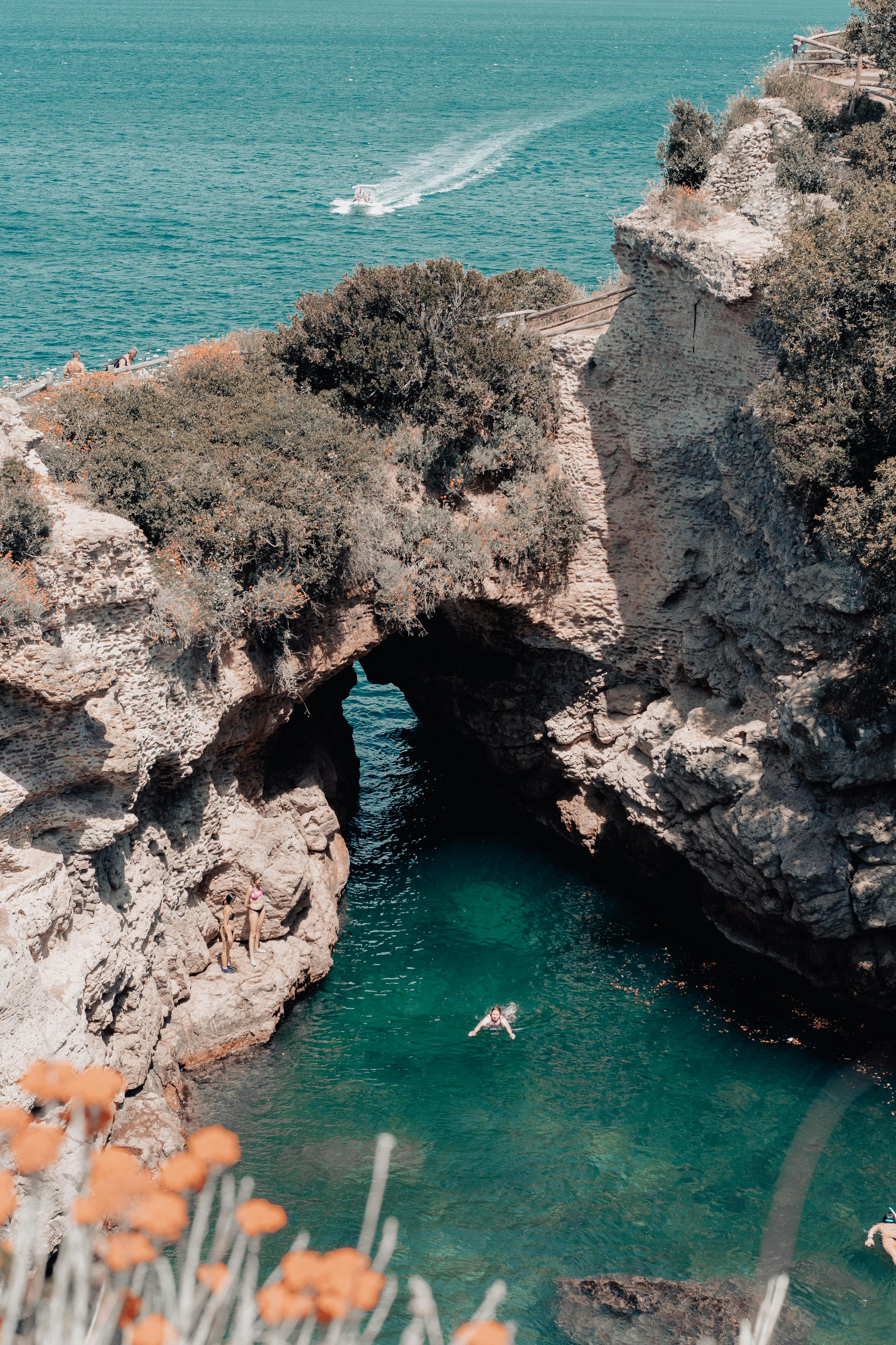 Aerial view of a person swimming in the clear sea at Bagni Regina Giovanna near Sorrento, Italy