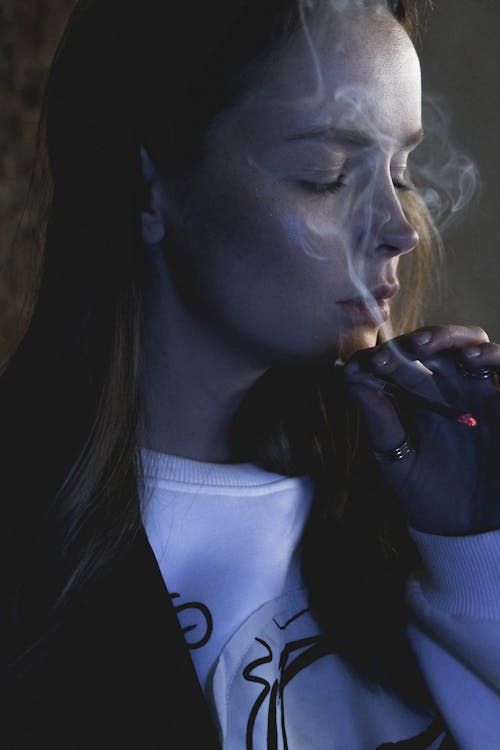 Free Woman in Black Blazer Smoking Cigarette Stock Photo