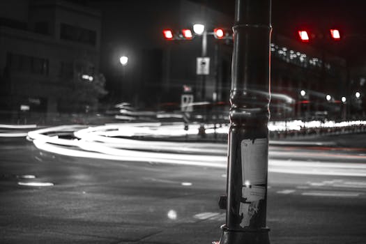 Dynamic city street view at night with long exposure capturing light trails and traffic.