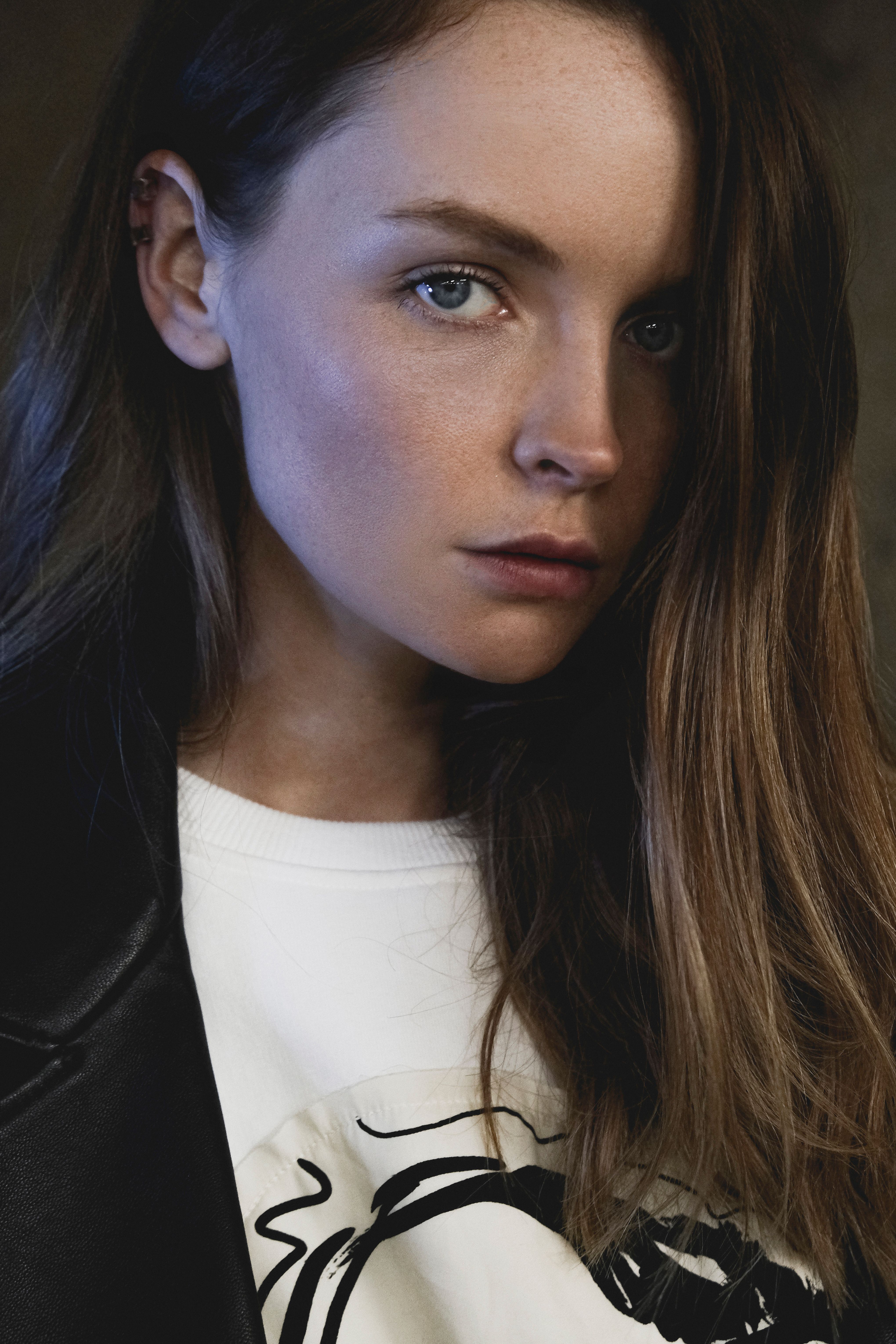 A captivating portrait of a woman with intense gaze in a studio setting.