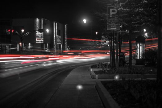 Long exposure photo capturing vibrant light trails on a city street at night.