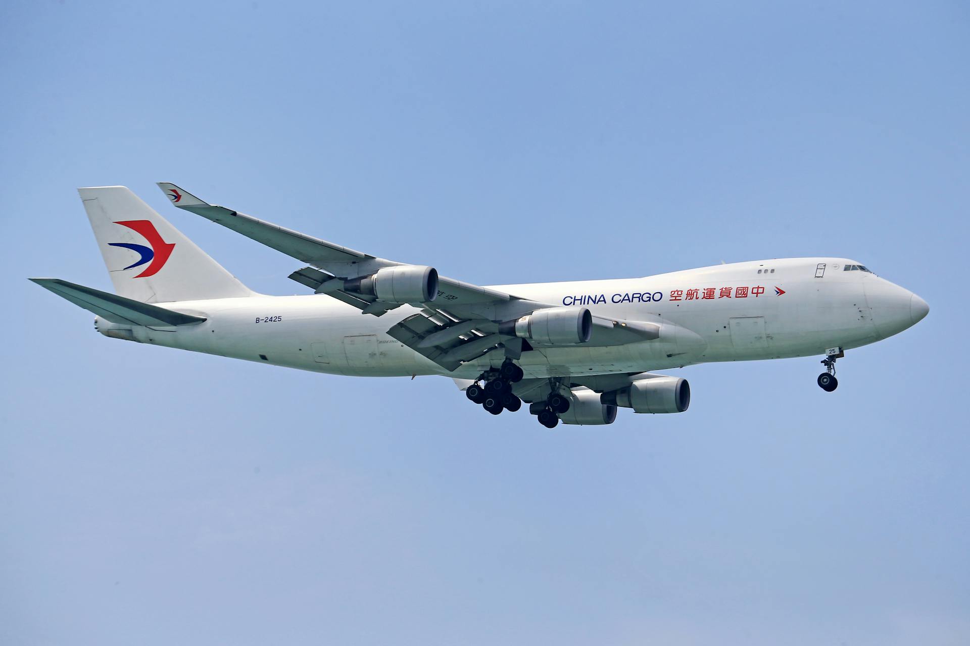 China Cargo airplane in flight, clear blue sky backdrop, showcasing air logistics.