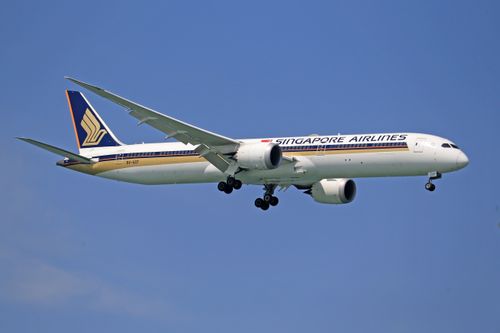Free A Singapore Airlines Boeing 787 Dreamliner flying against a clear blue sky. Stock Photo