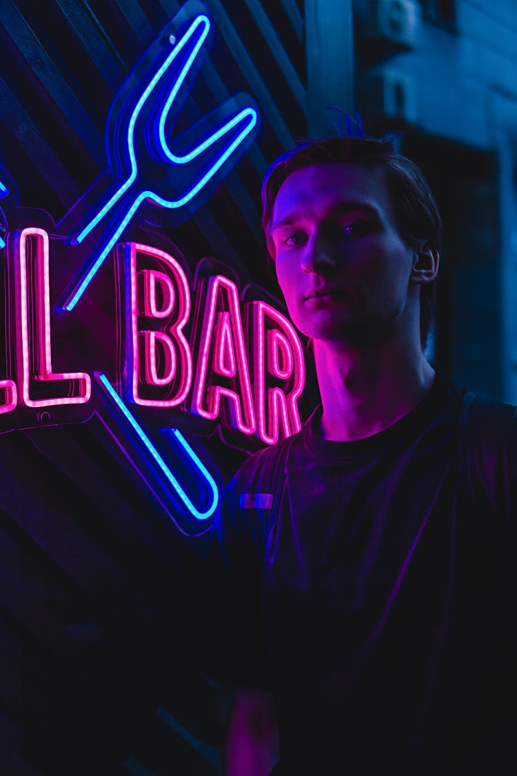 Portrait Of Young Man On Neon Sign