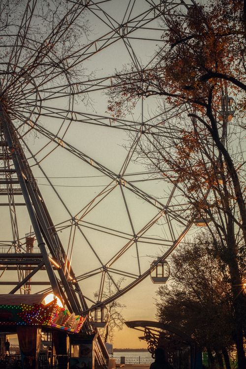 Free Ferris wheel silhouette against a sunset sky in Khabarovsk amusement park. Stock Photo