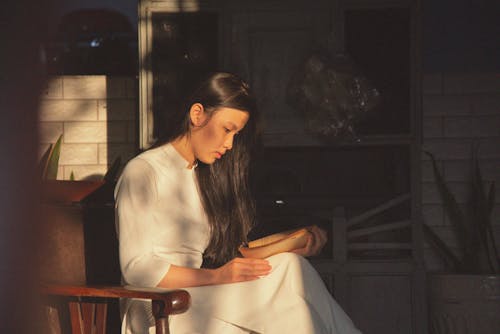 Side View of a Woman Reading a Book