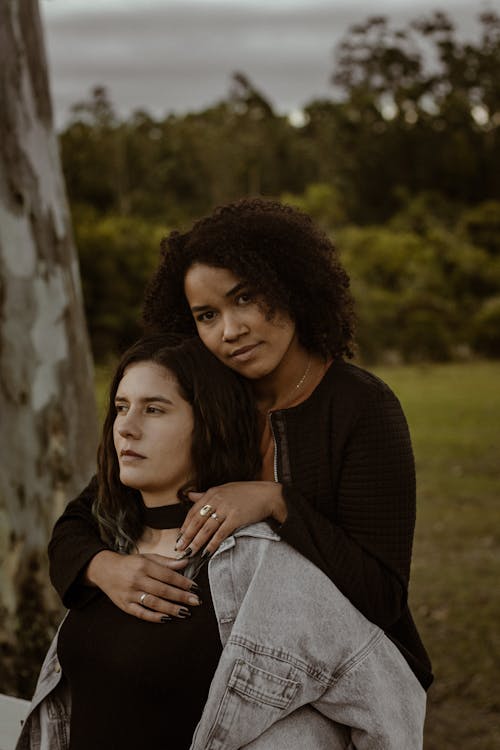 Free A Woman Hugging a Woman From Behind Stock Photo