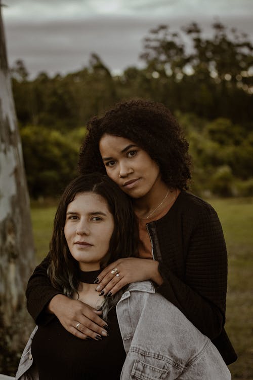 Free 
A Woman Hugging a Woman From Behind Stock Photo