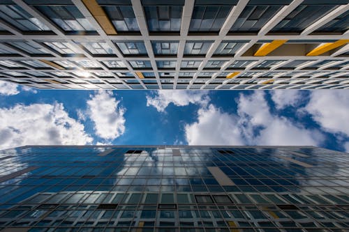 Free White Clouds over Glass Building Stock Photo