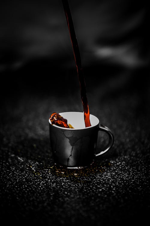 Brown Liquid Pouring on Black and White Ceramic Mug Selective Color Photography