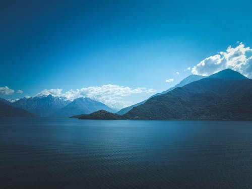 View of a Sea and Mountains Under Blue Sky