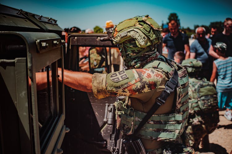 Soldier In A Uniform By The Military Vehicle 