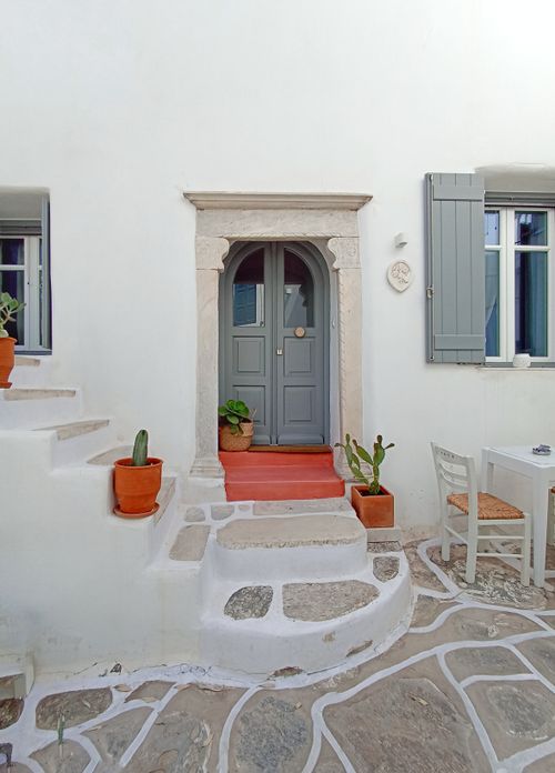 Free Elegant entrance of a Mediterranean style house with potted plants and stone steps. Stock Photo
