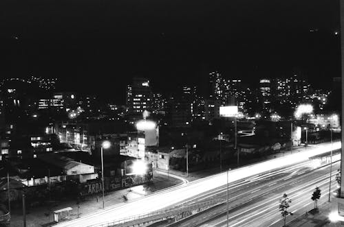 Grayscale Photo of a City During Nighttime