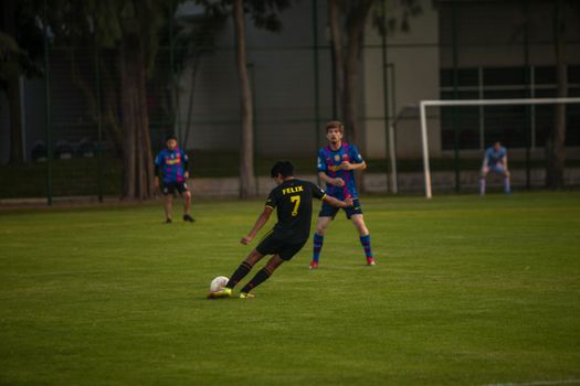 Players compete vigorously on a soccer field, showcasing athletic skill and teamwork.