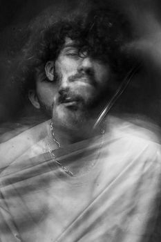 Ethereal black and white portrait featuring a blurred double exposure effect.