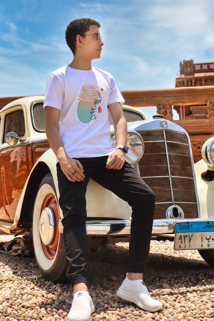 A Man Posing By The Classic Car