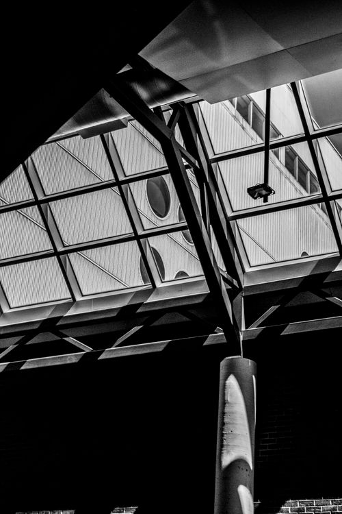 Free Black and white view of a modern interior with geometric structures and columns. Stock Photo