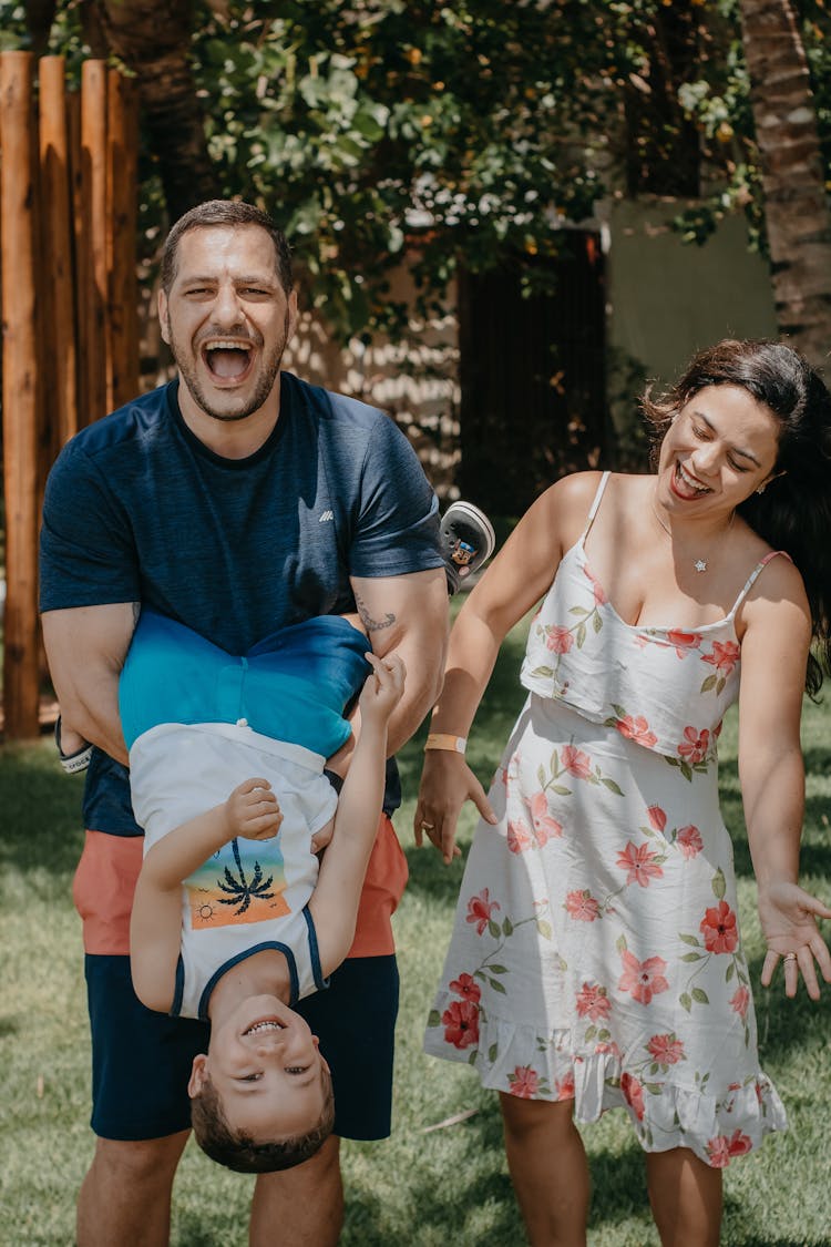 Happy Family Playing In Yard