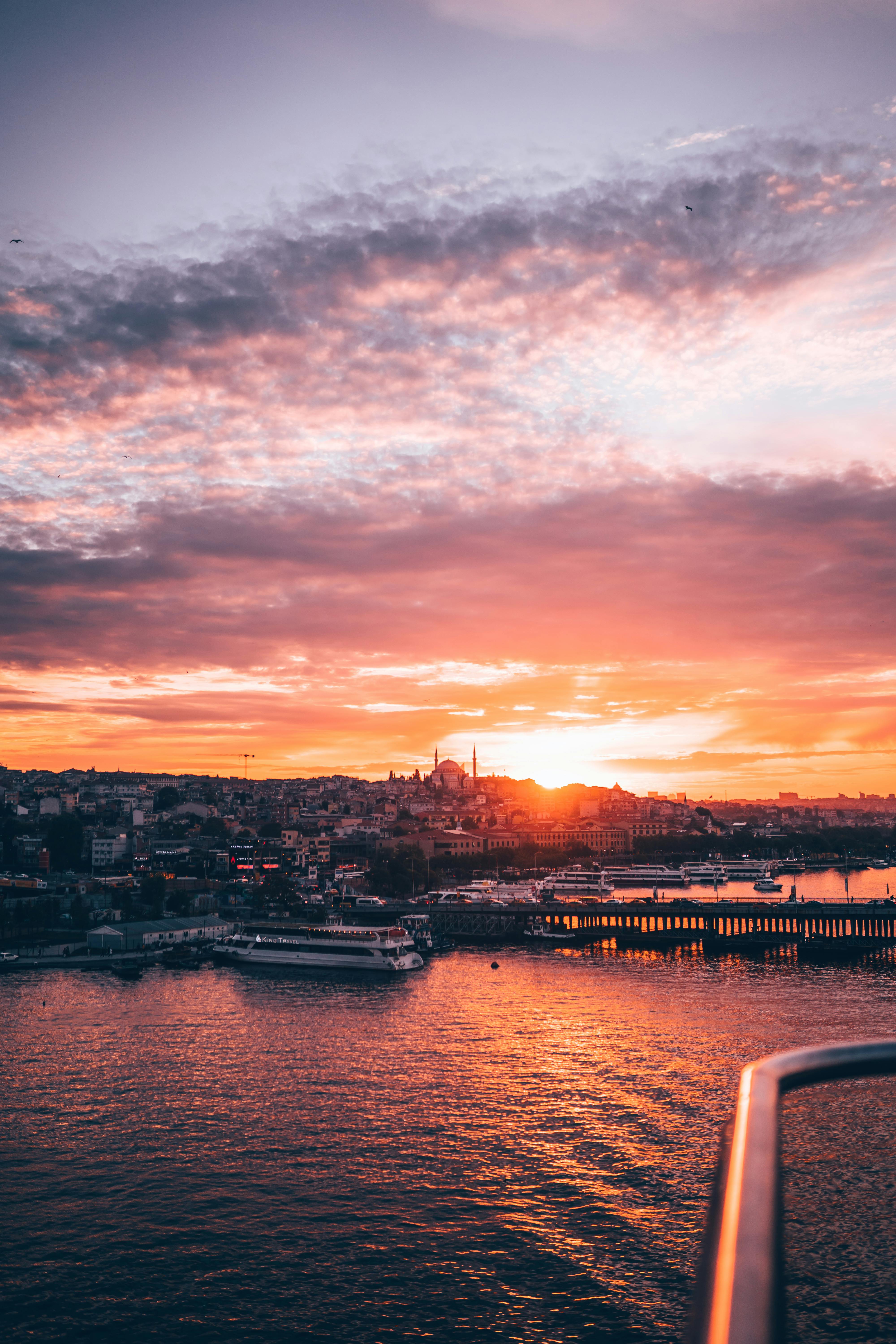 Captivating view of Istanbul's cityscape at sunset with vibrant skies above the Bosphorus.