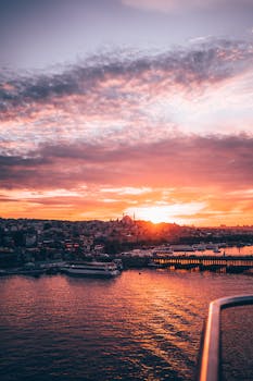 Captivating view of Istanbul's cityscape at sunset with vibrant skies above the Bosphorus.