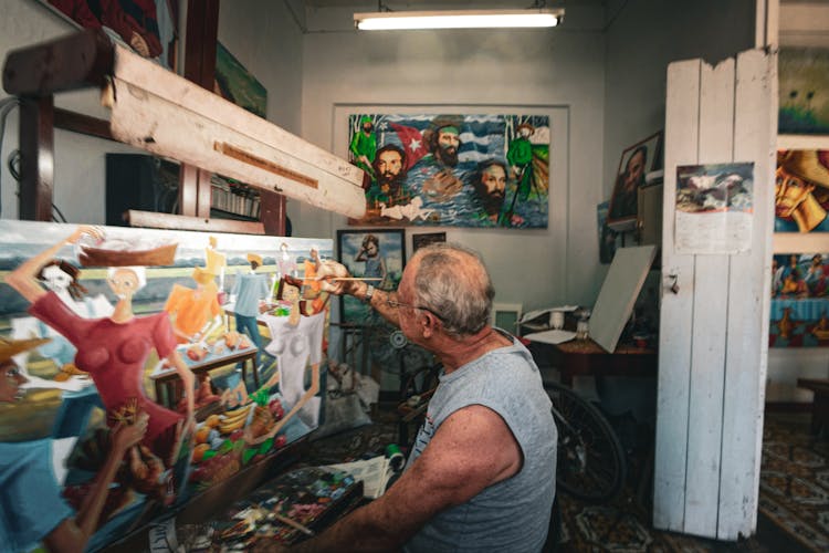 Old Man Drawing Modern Art Painting In Workshop