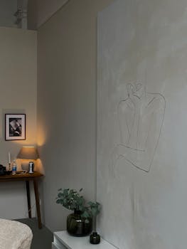 Stylish minimalist bedroom featuring abstract wall art and modern decor.