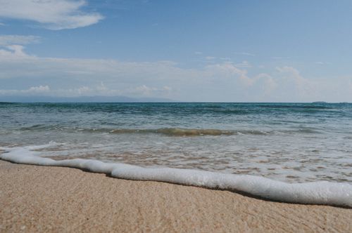 Free Tranquil seascape with gentle waves on a sandy beach in Mexico. Stock Photo