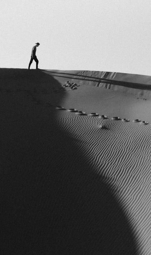 Person Walking on Sand