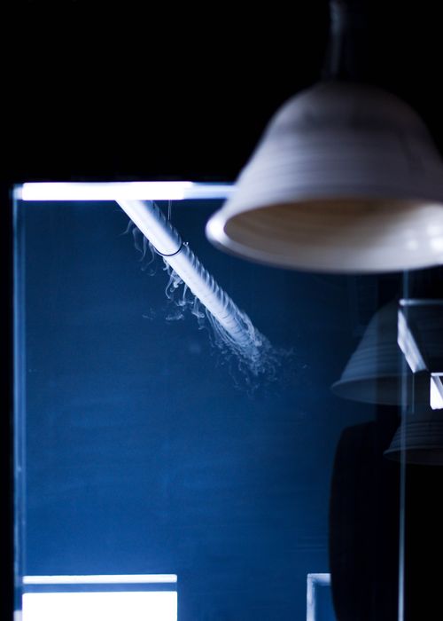 Free A minimalist view of a lamp and pipe with mist in a modern setting. Stock Photo